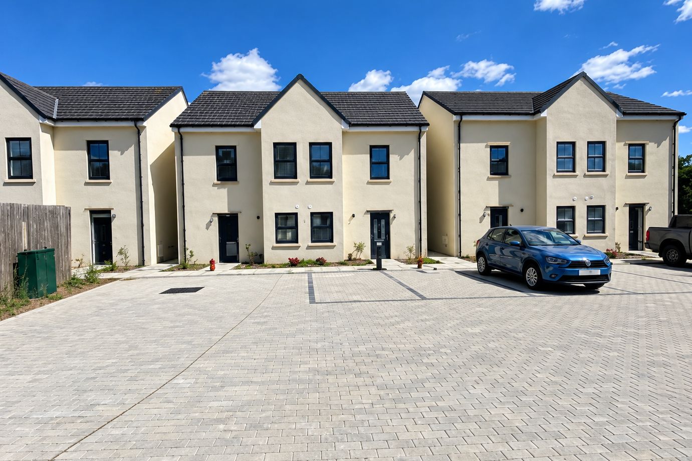 A row of newly built houses around a shared parking court