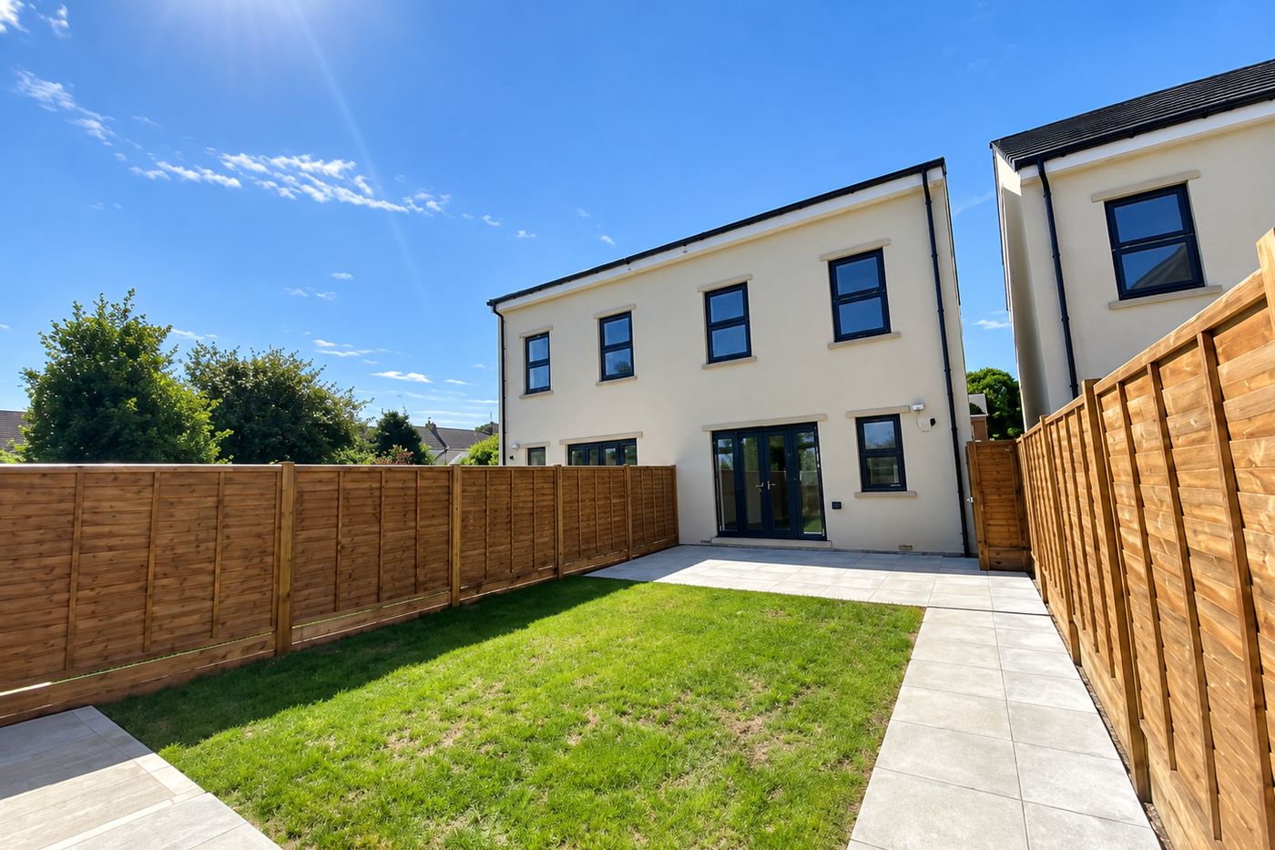 A private rear garden with a lawn, patio and fencing